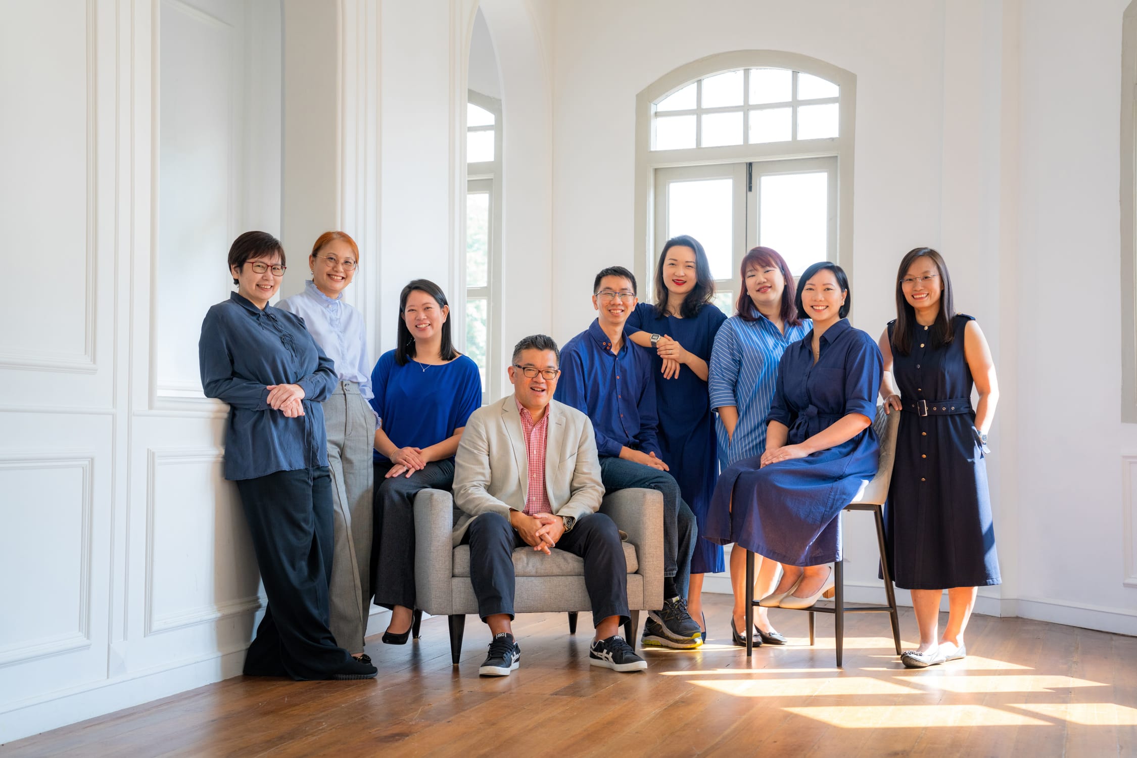 Corporate individuals and business professionals in a photography studio setting during a corporate photoshoot in Singapore, White Room Studio. Credit: White Room Studio Pte Ltd