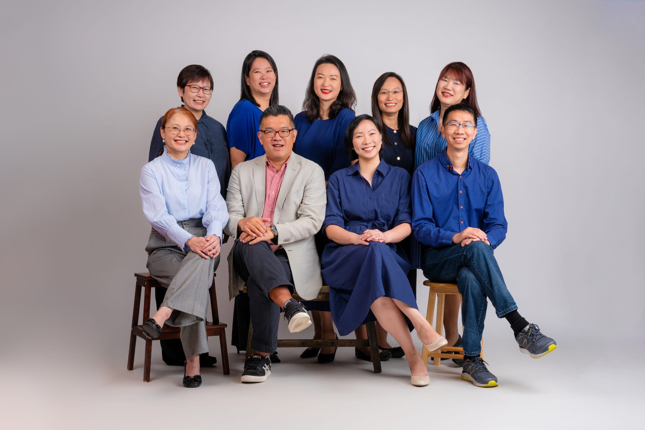 Corporate individuals and business professionals in a photography studio setting during a corporate photoshoot in Singapore, White Room Studio. Credit: White Room Studio Pte Ltd
